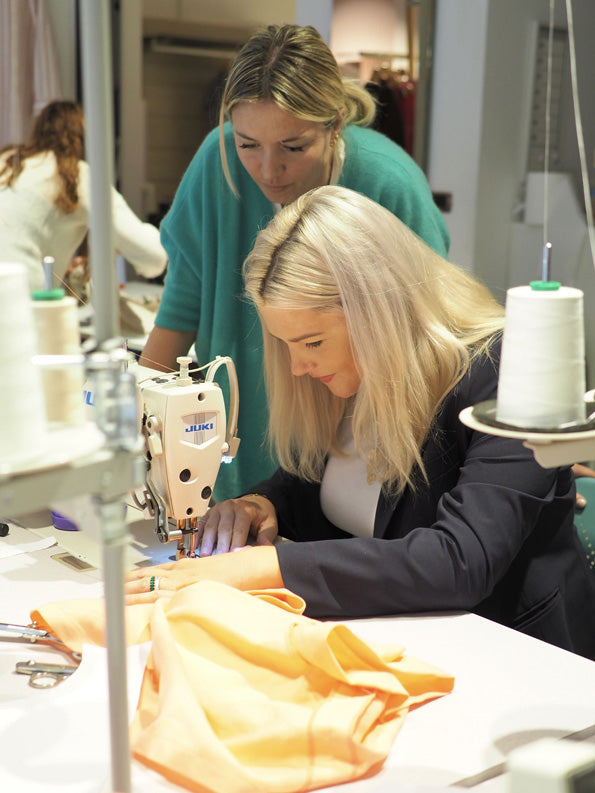 Marta Scarampi and Mary Hafner sew a collaborative garment