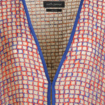 Alma Poncho in orange and blue, close-up