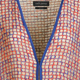 Alma Poncho in orange and blue, close-up