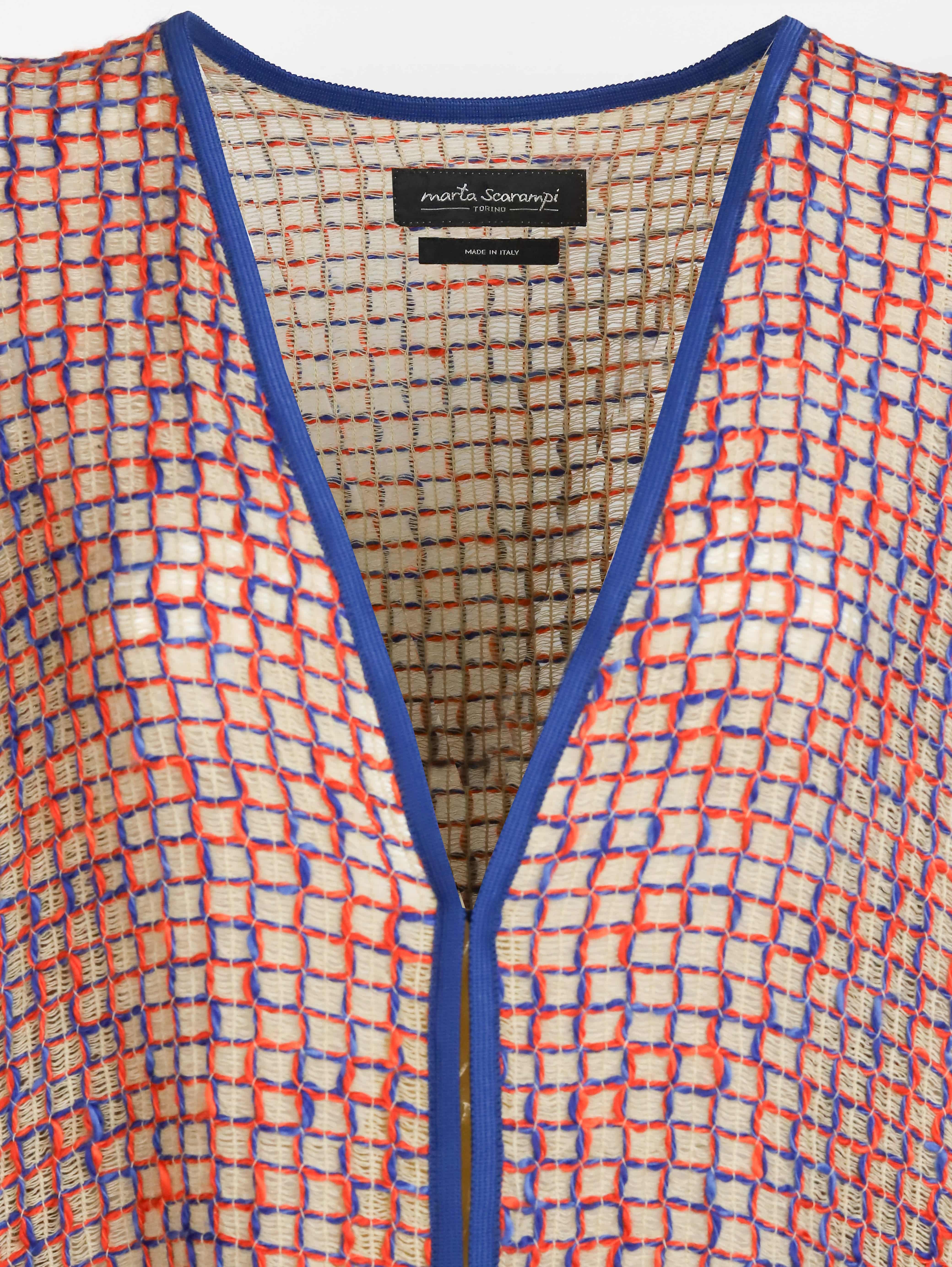 Alma Poncho in orange and blue, close-up