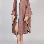 Alma Poncho in orange and blue, front view