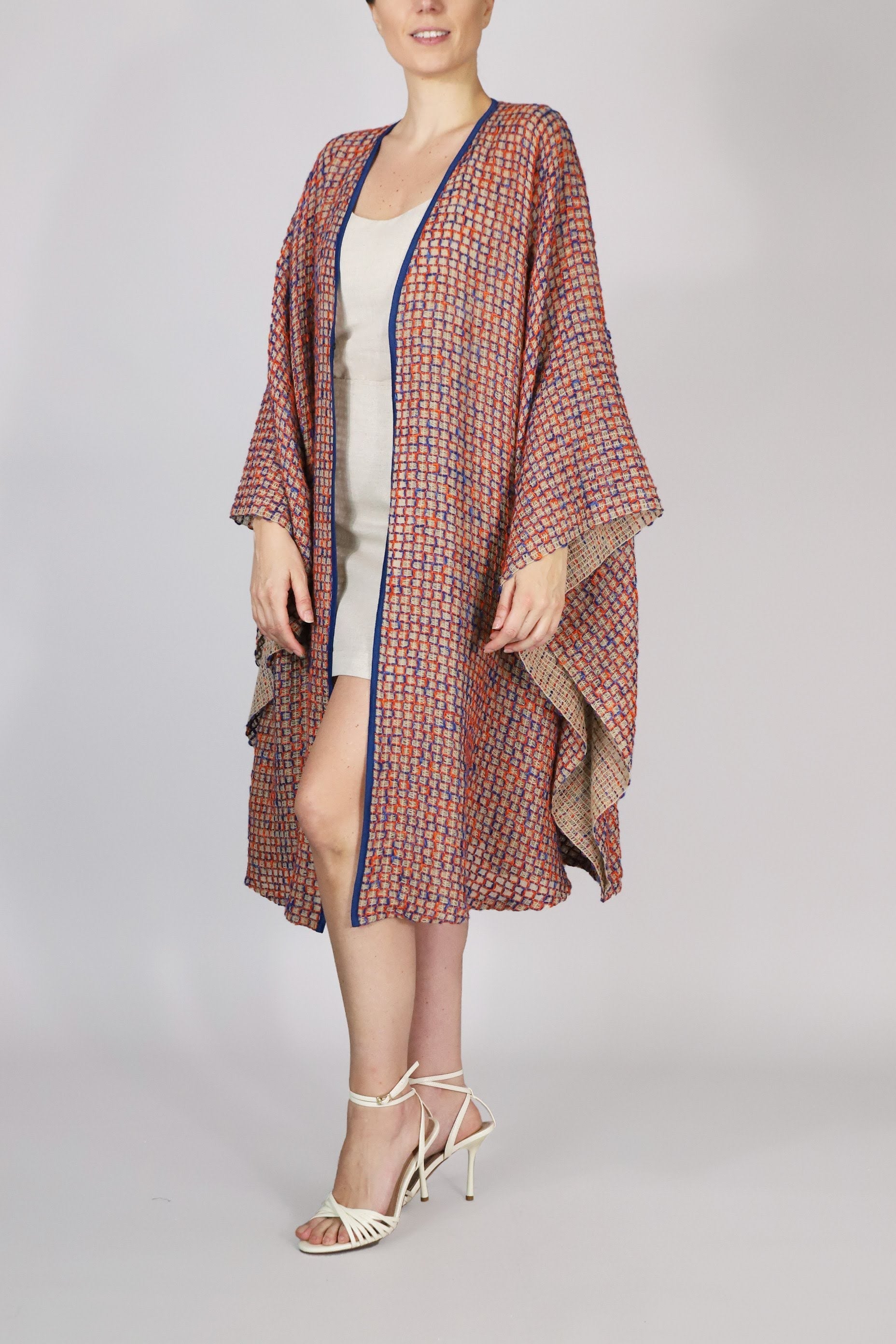 Alma Poncho in orange and blue, front view