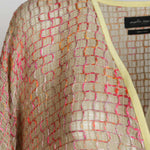 Alma Poncho in pink and yellow, close-up