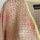 Alma Poncho in pink and yellow, close-up